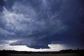 Classic supercell storm type with a rotating wall cloud below 