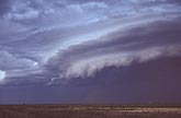 Shelf cloud with ruffled lower ledge and smooth-edged layers above