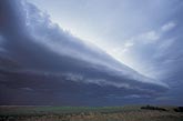 A long, multi-layered shelf cloud Arcus cloud ahead of a storm