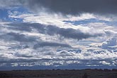 A mixed sky with layered smooth and woolly clouds
