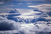 An aerial cloud landscape view of veiled cloud tops