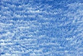 Fine cloud texture does a lively dance in a pure blue sky