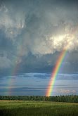 A double rainbow in a ruffled stormy sky