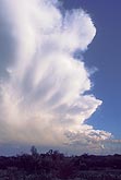 Sweeping puffs of storm cloud explode high into the sky
