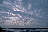 A woolly cloud sheet spreads a meditative light on a winter landscape