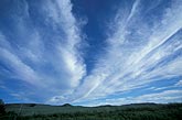 Cirrus bands fan across the sky creating artistic cloud designs