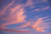 Abstract sky: glowing pink clouds in rhythmic waves