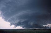 A beautifully sculpted wall cloud beneath a turbulent storm
