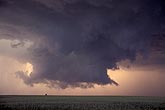 Close view of a wall cloud with inflow tail pointing toward the rain