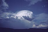 Small Cumulonimbus with a mass of Pileus, like a hat, above it