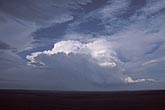A boiling Cumulonimbus cloud glows in a rhythmic skyscape