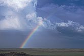 Hope dawns as a lucky rainbow arcs through stormy clouds