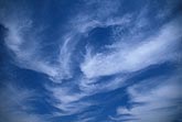 Swirling motion characterizes this sky full of wispy cloud.