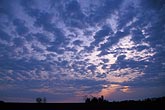 Drifting cloud fragments in a meditative twilight sky