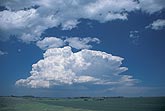 A small Cumulonimbus storm cloud exhibits crisply defined structure