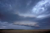 A supercell mesocyclone develops a wall cloud with tail cloud