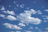 Cheerful abstract sky: puffy clouds float in a happy sky