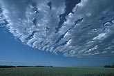 A sharply defined arc of cloud billows looks like a ship
