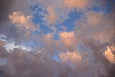 Purity glows from bright pink cloud tufts bathed in sunset light