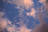 Abstract: sunset enchants puffy clouds as they dance with abandon