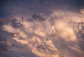 Twilight enchants the graceful folds of a storm cloud