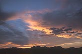 A golden twilight casts a quiet light on mountain clouds