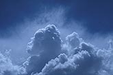 Aerial of heavenly clouds as shaded towers spurt up into a misty sky