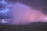 A dreamy pink rainstorm in a mysterious desert cloudscape