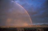 A rainbow mixed with dust and rain make for an eerie twilight scene