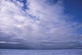 A Stratocumulus cloud sheet spreads outward from snow showers