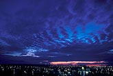 Cloud billows in a twilight sky over city