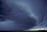 A sculpted shelf cloud approaches low to the ground