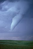 A close tornado with condensation funnel hanging low