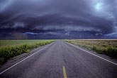 Wide view of massive black storm gust front (Arcus) over highway