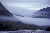 Layers of Stratus clouds above a river valley in the mountains