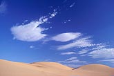 Lenticular Altocumulus clouds over desert sand dunes