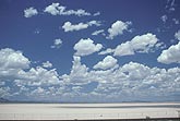 Intense heat has created scattered puffy clouds over desert sands