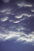 Silvery Mammatus clouds hand from a storm anvil