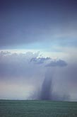 Landspout tornado made visible by black debris cloud
