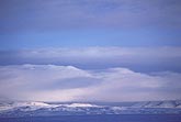 Wave clouds over mountains in winter