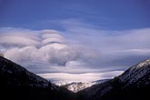 Standing wave clouds with rotor in mountains