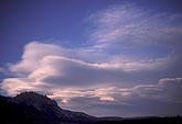 Serene cloudscape with flowing clouds over mountains