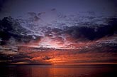 Meditative red sunset over still water