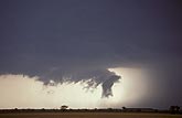 Peculiar wall cloud beside rain core on supercell