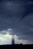 Tornado dirt column, part of sequence, with condensation funnel