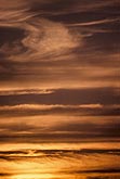 Meditative red sunset abstract with golden cloud strips