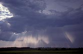 Soft crepuscular rays (rays of God) brush mystery onto a stormy sky