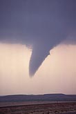 A tornado passes over a remote landscape