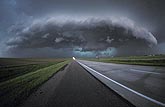 Very wide view of a severe storm over an interstate highway