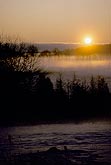 Dawn casts a golden glow on fog